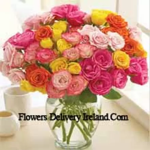 37 Mixed Colored Roses With Some Ferns In A Glass Vase