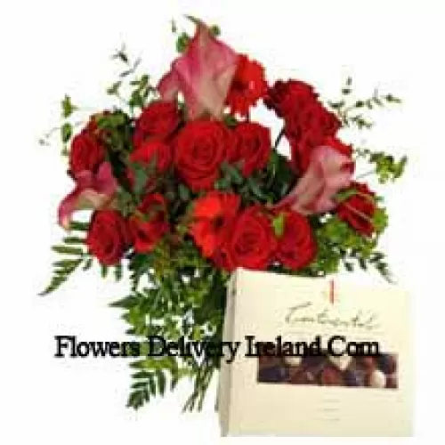 Red Gerberas And Red Roses In A Vase Along With A Box Of Chocolate