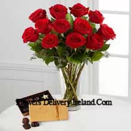 11 Red Roses With Some Ferns In A Vase And A Box Of Godiva Chocolates (We reserve the right to substitute the Godiva chocolates with chocolates of equal value in case of non-availability of the same. Limited Stock)